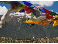 Prayer flags fluttering in a typical Mustang landscape, Dhumba Lake